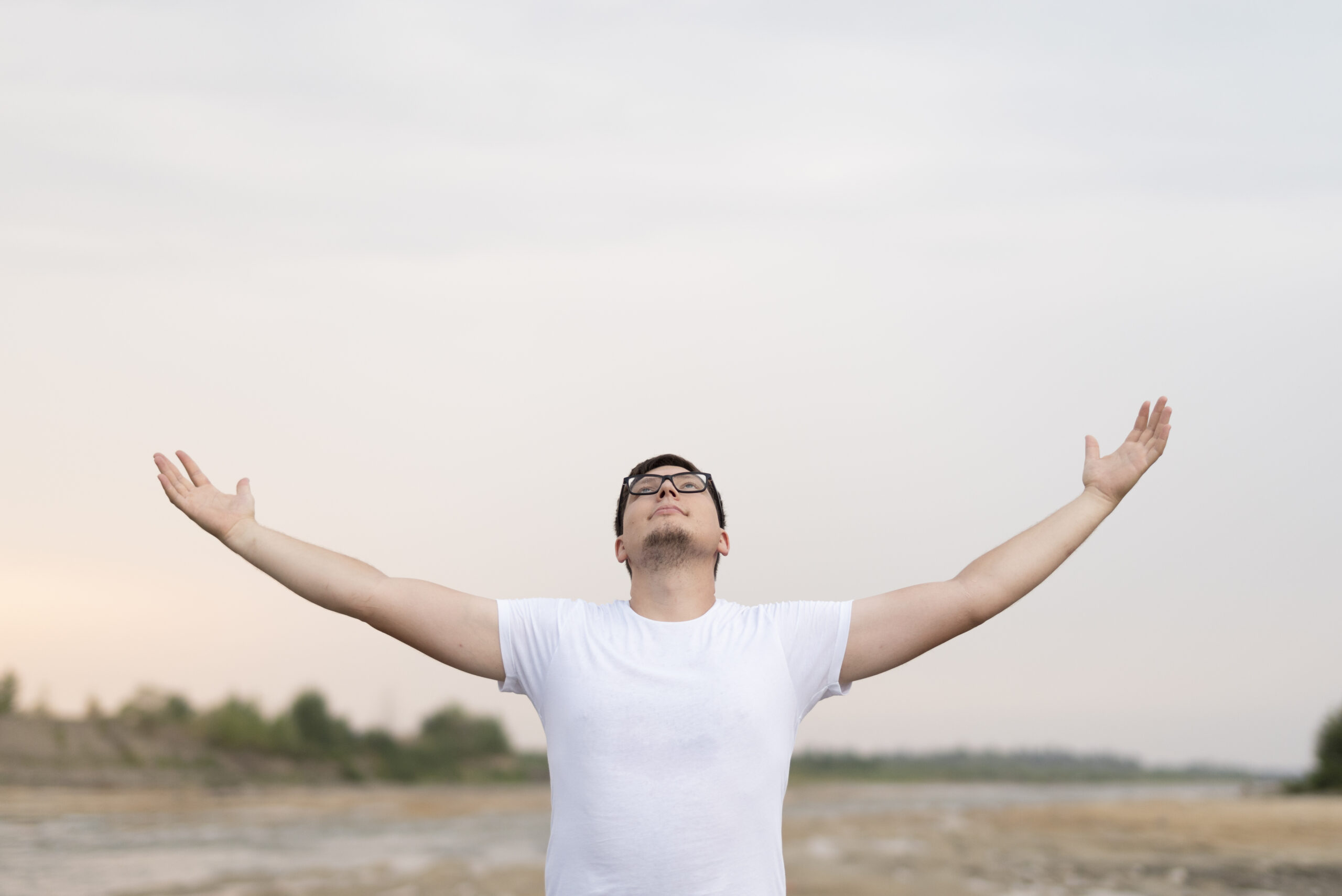 A peaceful person looking at the horizon symbolizing forgiveness and mental healing.